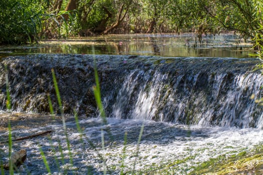 Close view of a small waterfall on a small stream of water.