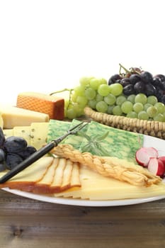 a white plate with different cheeses