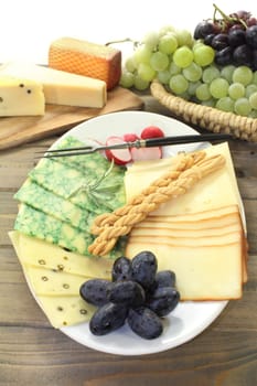 a white plate with different cheeses