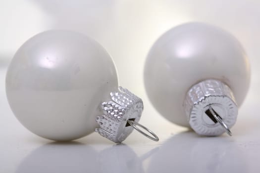 two white Christmas baubles