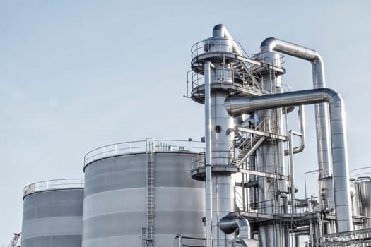 View of an industrial oil refinery with shiny tubes.