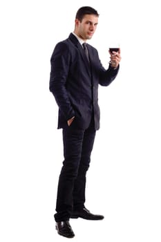 View of a young man holding a red glass of fine wine isolated on white studio background.