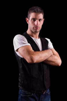 View of a young business man on a relaxed pose isolated on a black background.