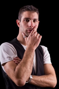 Cute young male man thinking isolated on a black background.