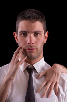 View of sensual scene where female hands touch a handsome man.