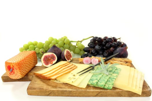 a wooden board with different cheeses