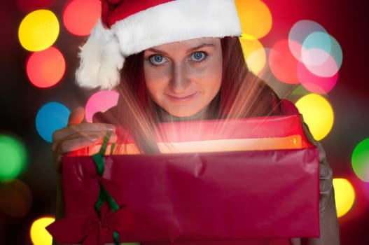 happy young woman opening gift box