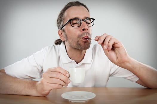 Man is drinking espresso
