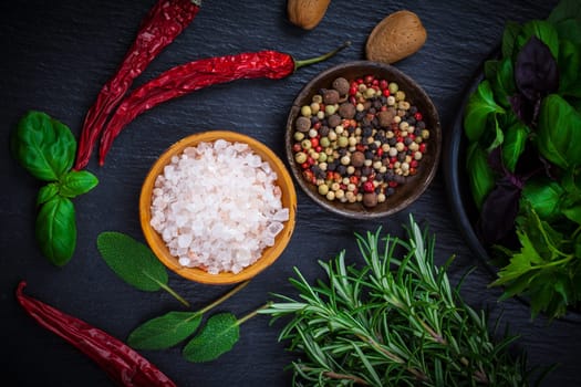 Spices and herbs on black background