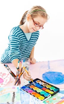 Casual schoolgirl painting with watercolor on white background