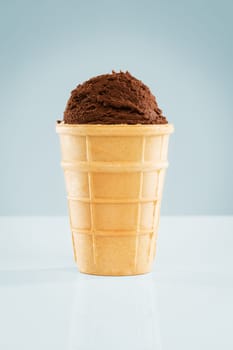 A chocolate ice cream ball in a waffle