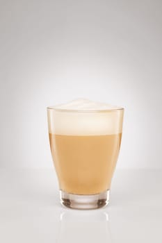 Small cappuccino on grey background