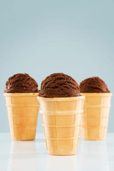 Three standing waffles with chocolate ice cream