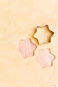 Stars cut out of dough for cookies for Christmas