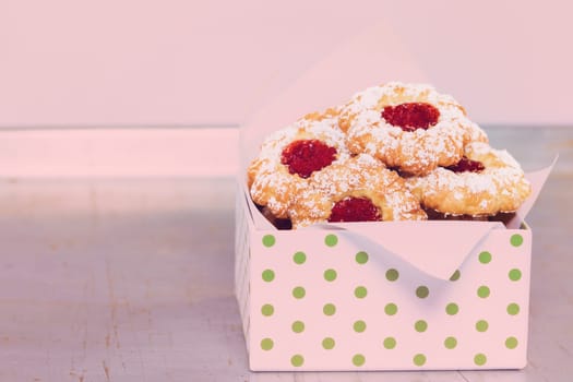 Cookies with jam and icing sugar for Christmas in a nostalgic light