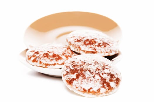 Gingerbread slides from brown plates on white background