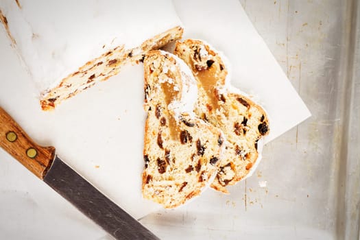 Traditional Christmas stollen on silver baking tray from above