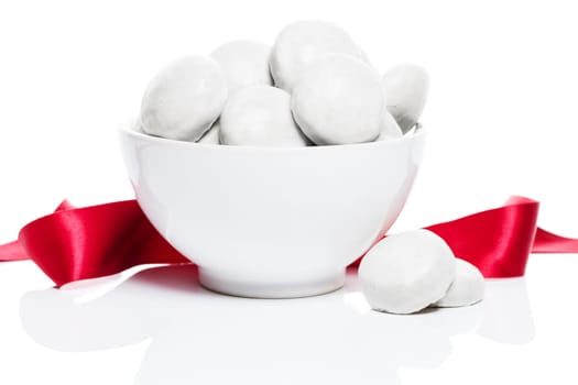 White gingerbread Gingerbread in white shell with red ribbon on white background