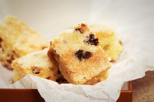 Close-up of a small piece of stollen for Christmas on baking paper
