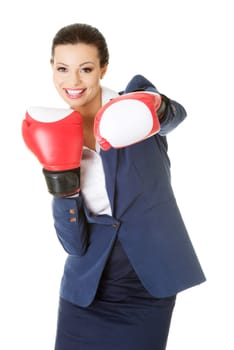 Young businesswoman with boxing gloves, isolated on white background