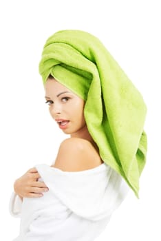 Attractive woman with a green towel on her head and bathrobe, isolated on white