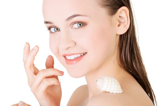 Beautiful face of spa woman with healthy clean skin and sea shell. Isolated on white.