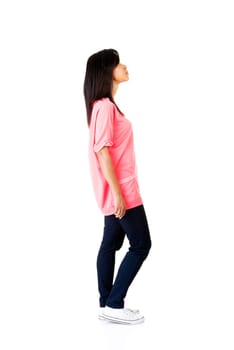 Young casual woman looking up, isolated on white