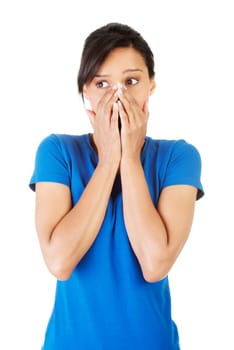 Young scared woman covering the mouth. Isolated on the white background.