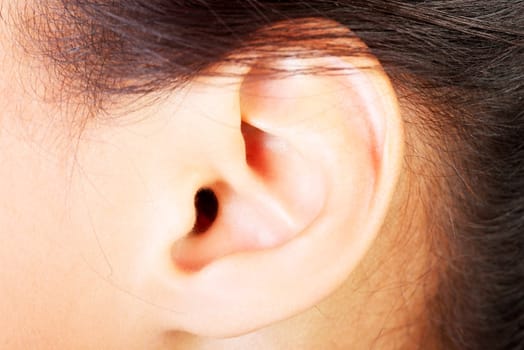 Young woman ear closeup.