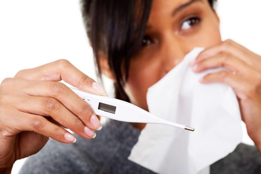 Young sick woman checking her temperature , isolated