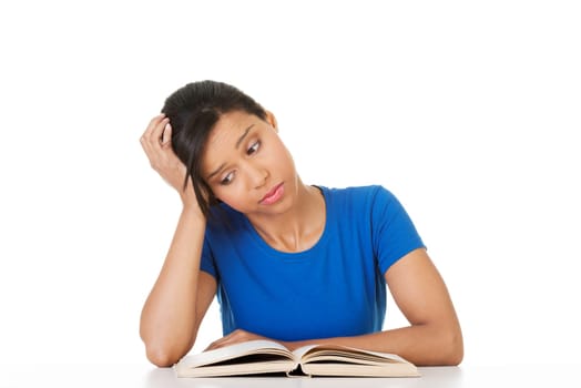 Woman studying at the desk being tired, isolated on white