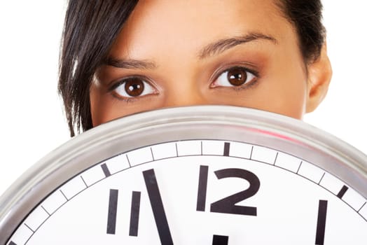 Portrait of shocked woman with clock over white background