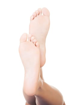 Beautiful female a foot and a heel lifted upwards on a white background