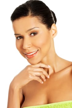 Beautiful happy woman after bath or spa, covered by green towel