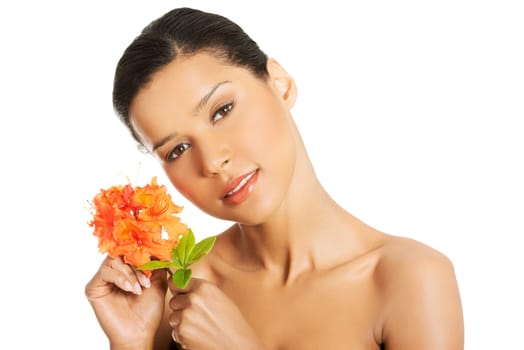 Portrait of beautiful young exotic woman with health skin and with flower