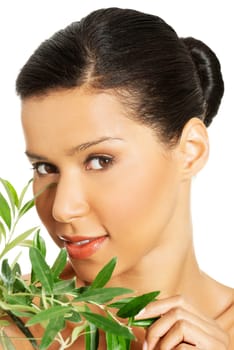 Portrait of beautiful young exotic woman with health skin and with olive tree