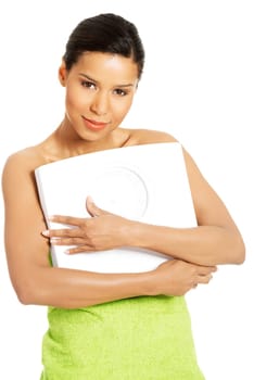 Happy woman with scale. Weight-loss concept.