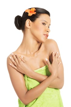 Portrait of beautiful young exotic woman with health skin and with flower