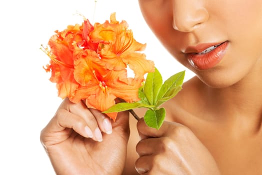 Portrait of beautiful young exotic woman with health skin and with flower