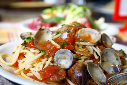 Close view of a tasty and typical spaghetti with clams dish from Italian cuisine.