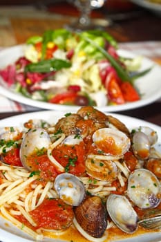 Close view of a tasty and typical spaghetti with clams dish from Italian cuisine.