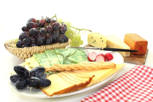 a white plate with different cheeses