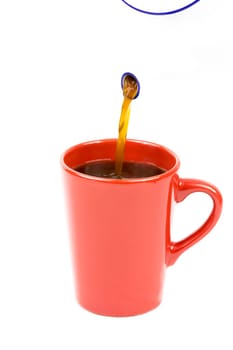Coffee is poured from a pot into a cup