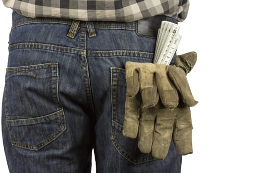 Ruler and work gloves in a trouser pocket
