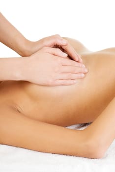 Young woman relaxing in spa. Breast massage.