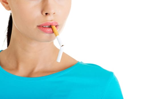 Young woman with broken cigarette. Stop smoking concept.
