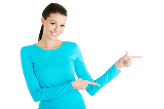 Happy , excited young woman pointing on copy space, isolated on white
