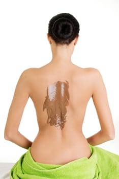 Pretty young woman relaxing at spa. Isoalted on white