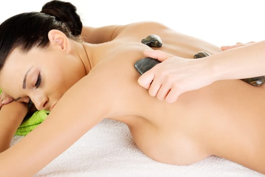 Beauty woman relaxing in spa. Stone massage.