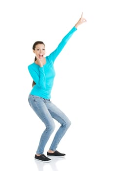 Happy , excited young woman pointing on copy space, isolated on white